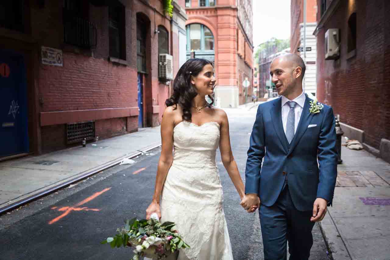 Bride and groom walking hand-in-hand for an article on non-floral centerpiece ideas