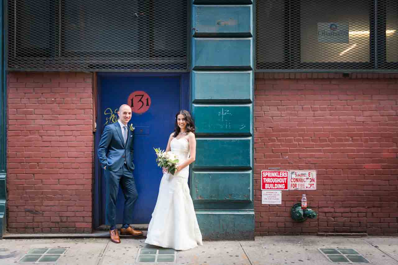 Bride and groom in colorful doorway for an article on non-floral centerpiece ideas