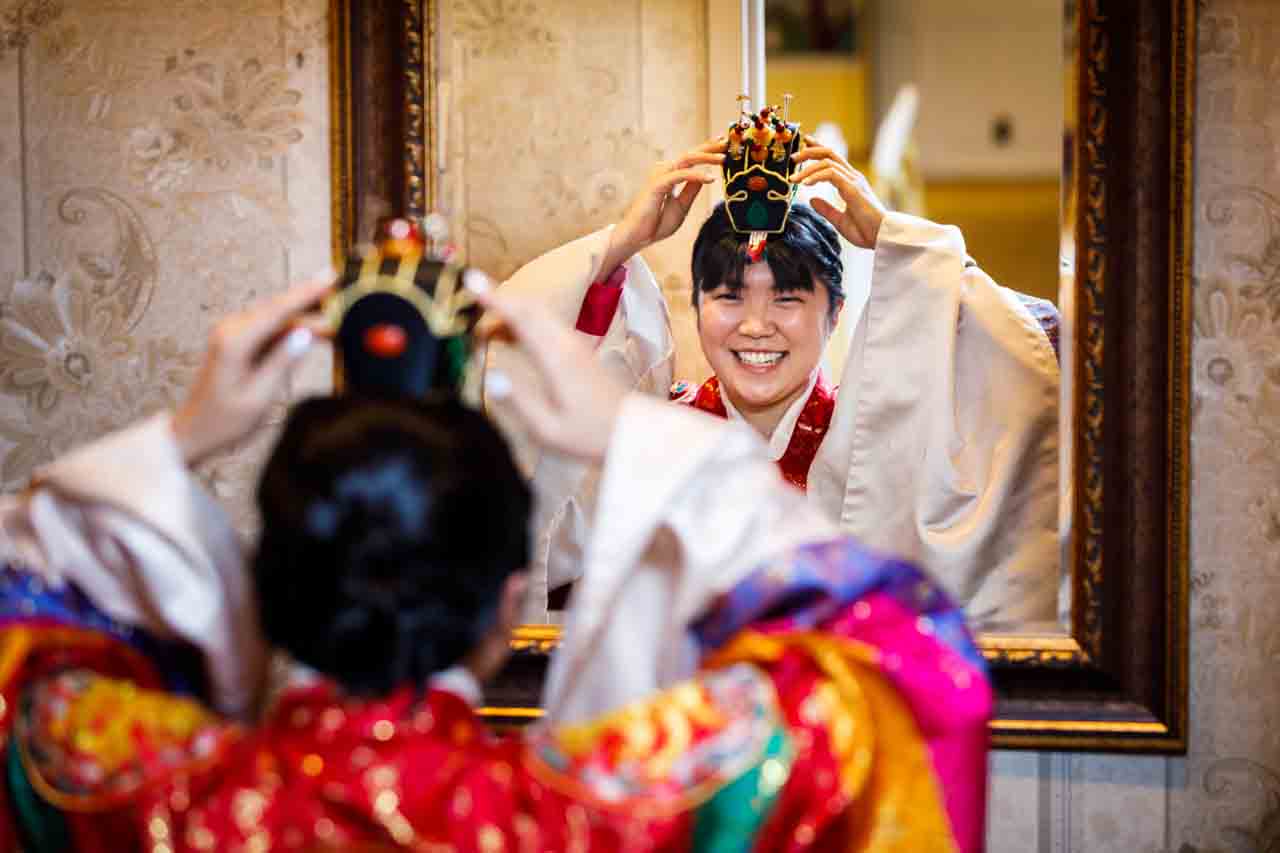 Bride adjusting jokduri at traditional Korean pyebaek ceremony