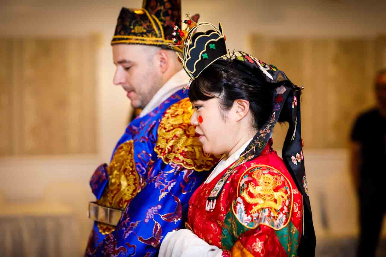 Bride and groom in profile at traditional Korean pyebaek ceremony