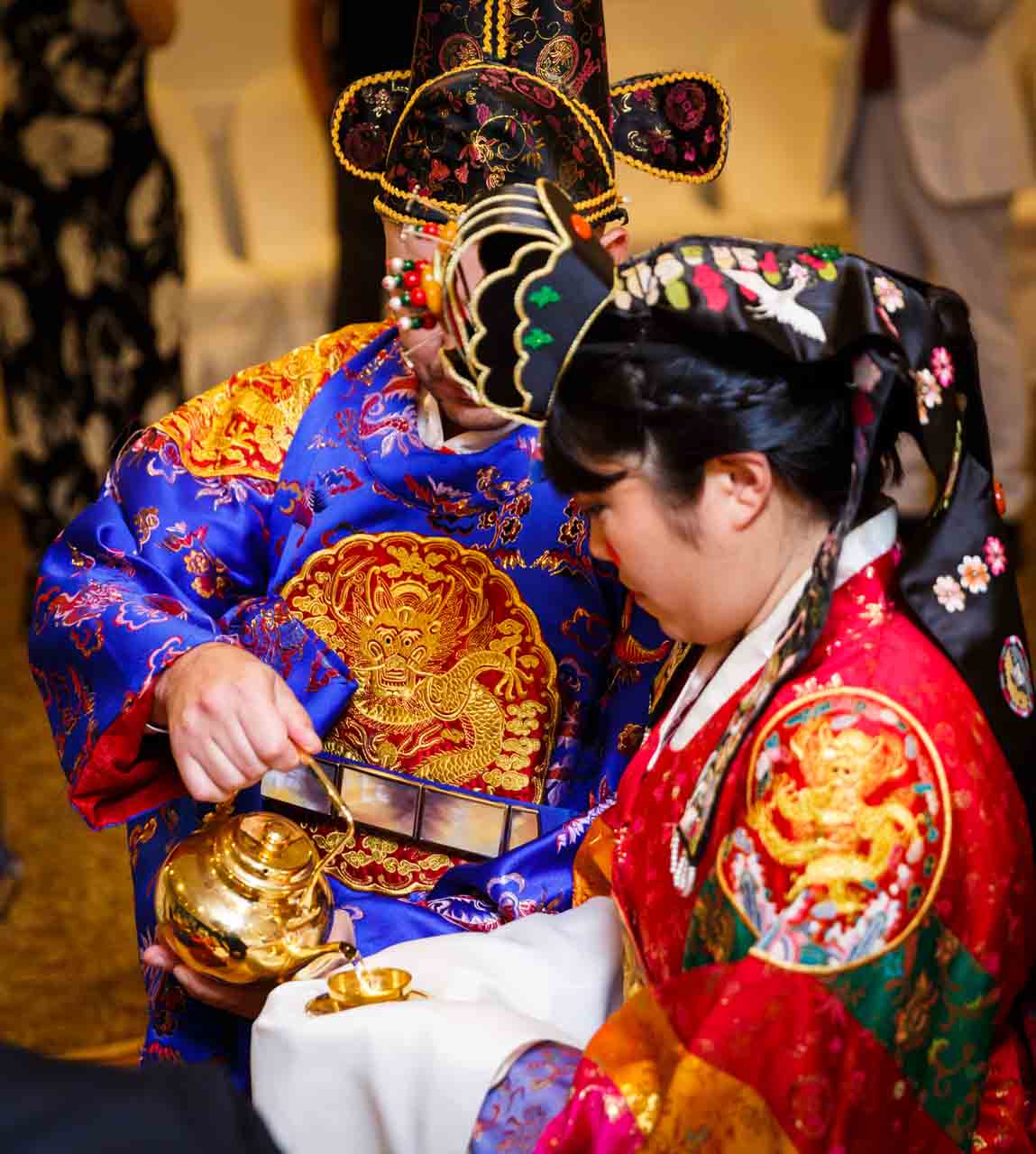 Groom pouring rice wine at traditional Korean pyebaek ceremony