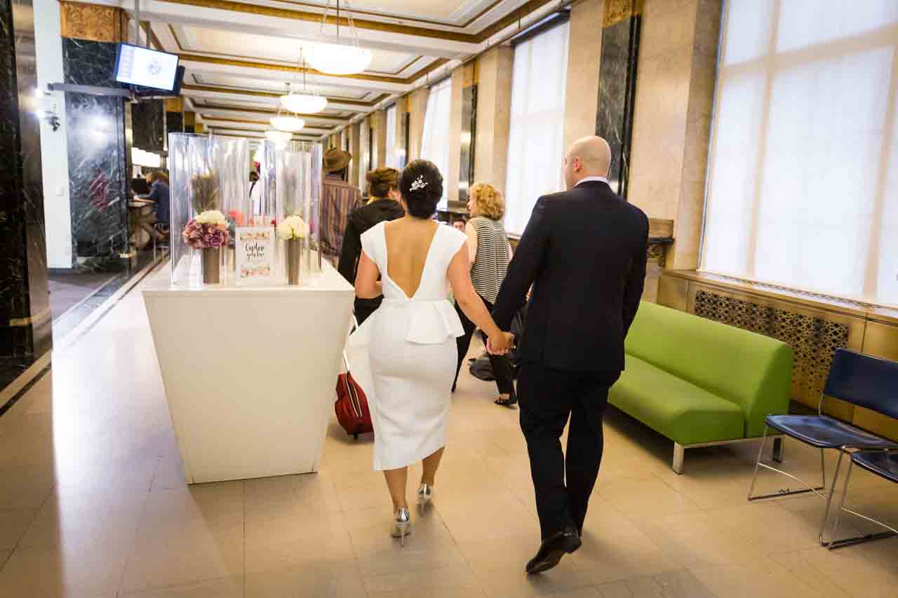 Bride and groom walking into City Clerk's Office