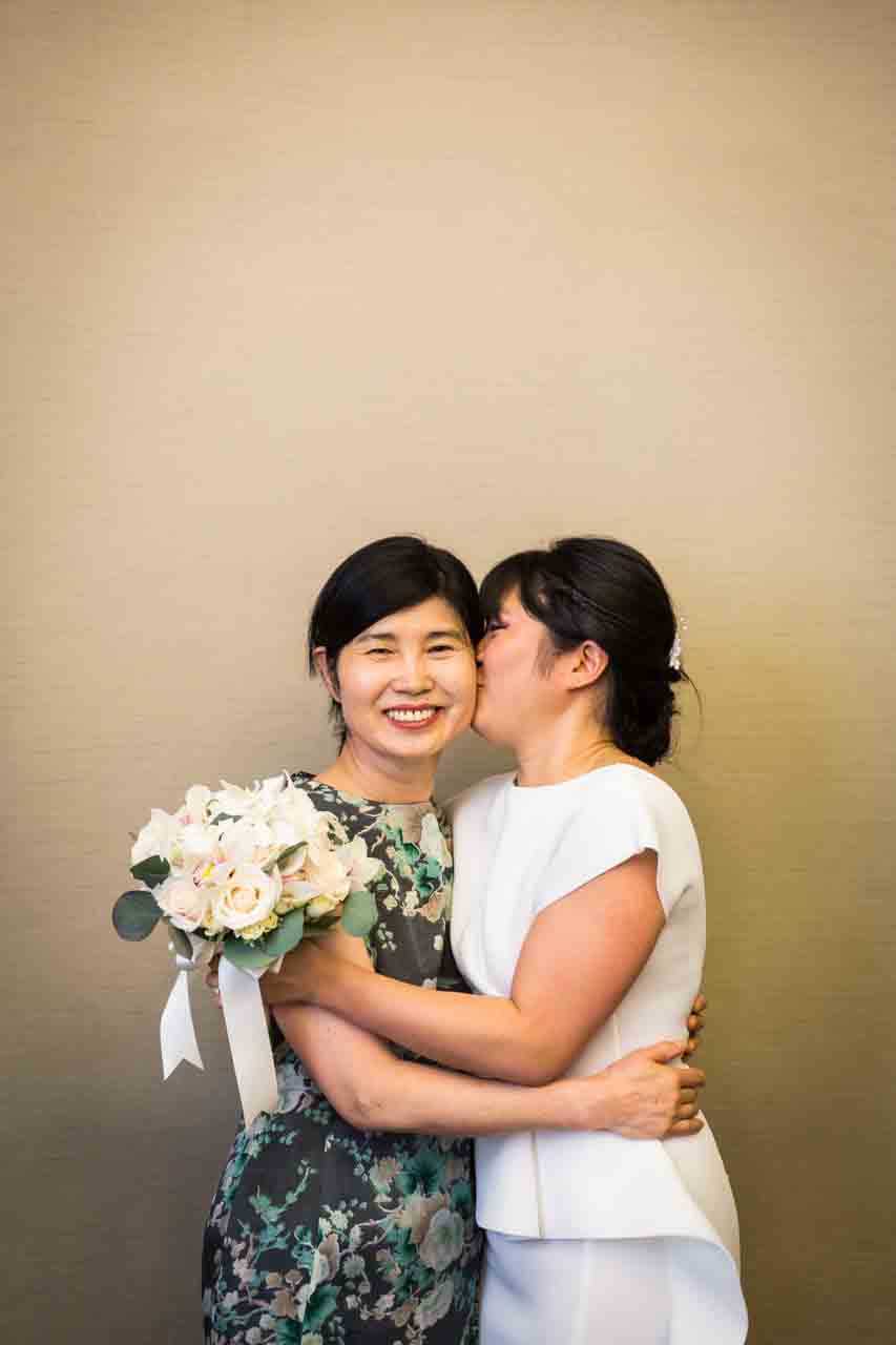 Bride kissing mother before NYC City Hall wedding