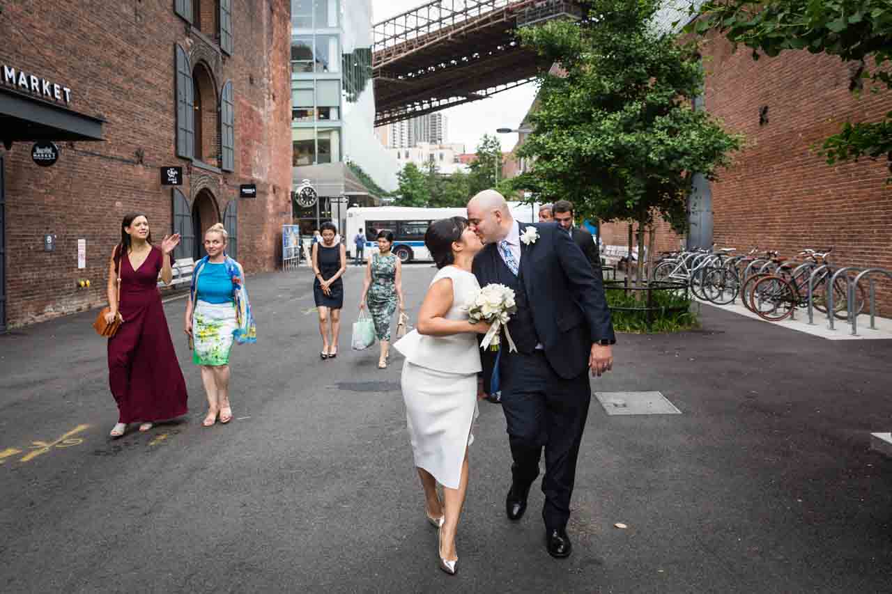 Bride and groom kissing in Brooklyn Bridge Park