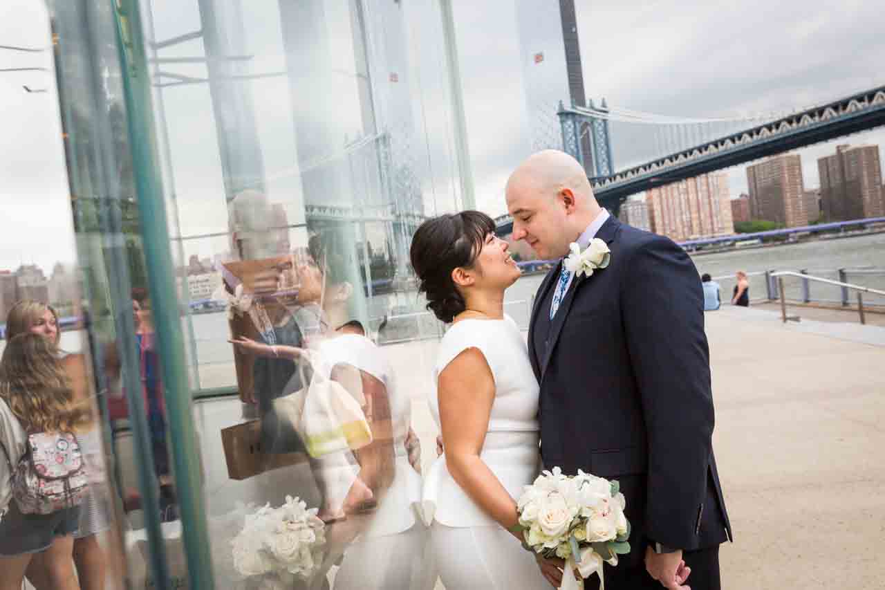 Bride and groom kissing against Jane's Carousel