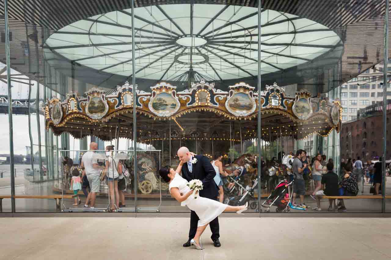 Bride and groom dancing in front of Jane's Carousel in Brooklyn Bridge Park