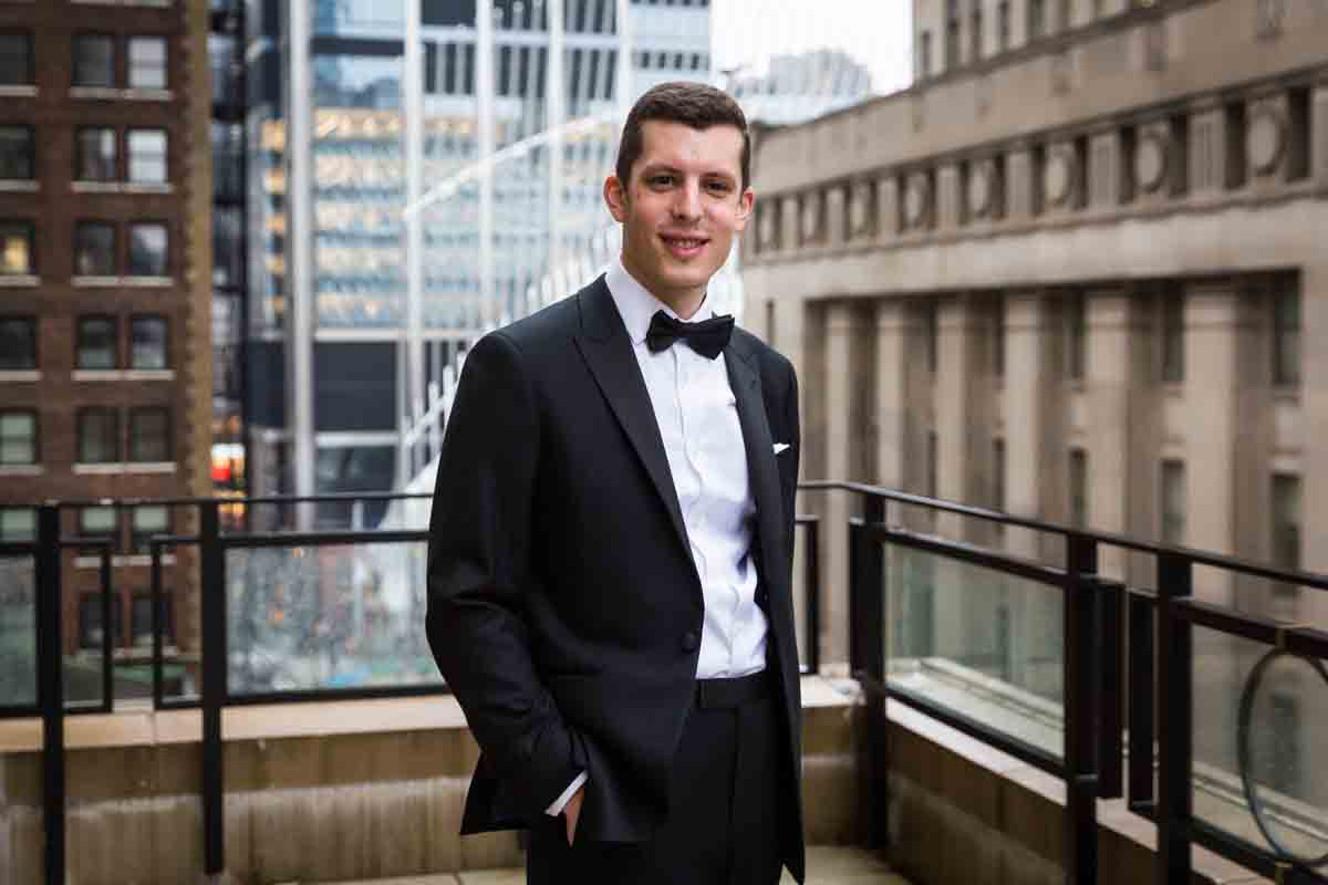 Portrait of groom with hands in pocket on terrace of Four Seasons Hotel New York Downtown