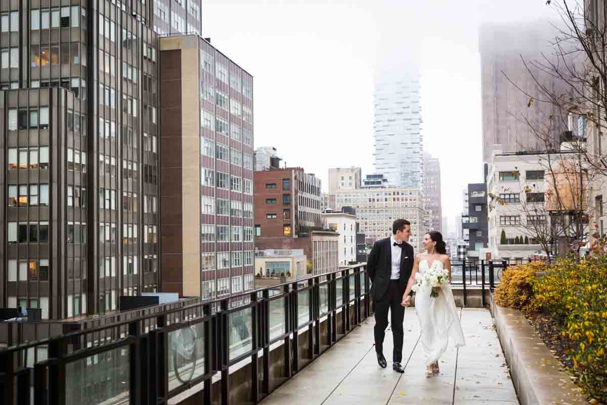 Bride and groom walking on terrace at Four Seasons Hotel New York Downtown