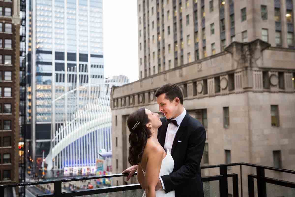 Bride and groom looking at each other on terrace of Four Seasons Hotel New York Downtown