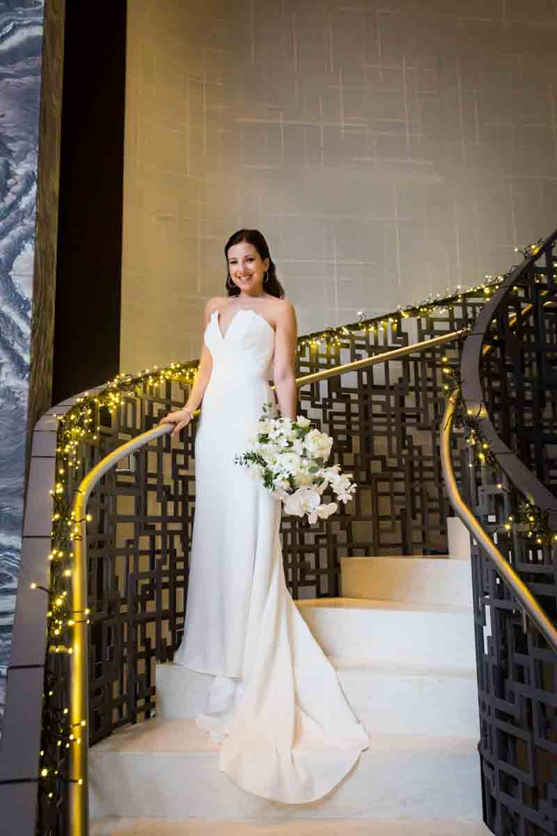 Bride posed on staircase of Four Seasons Hotel New York Downtown
