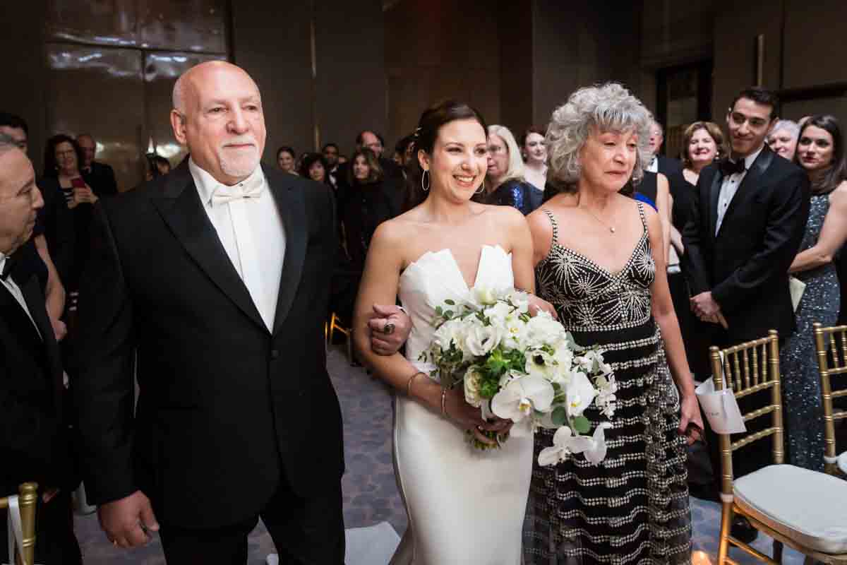 Bride and parents walking down the aisle at a Four Seasons Hotel New York Downtown wedding