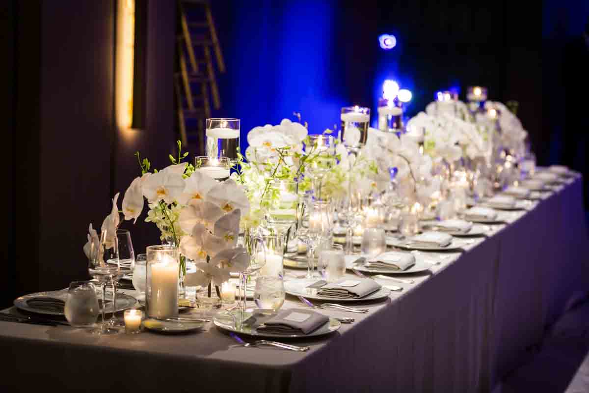 White floral centerpieces and candles at a Four Seasons Hotel New York Downtown wedding