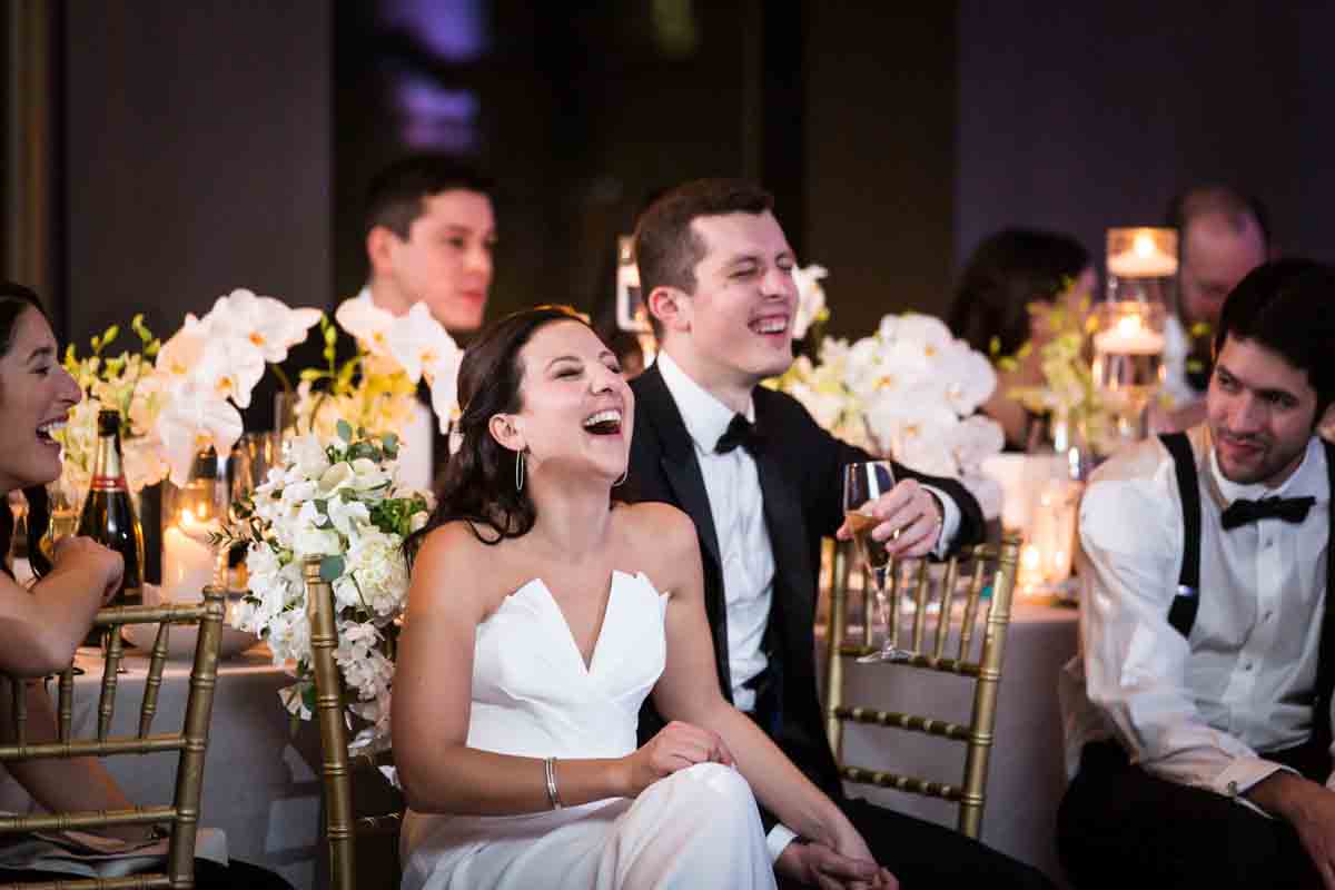 Bride and groom laughing during toasts at a Four Seasons Hotel New York Downtown wedding