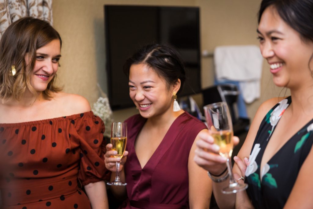 Bridesmaids laughing and holding champagne before Bronx Zoo wedding