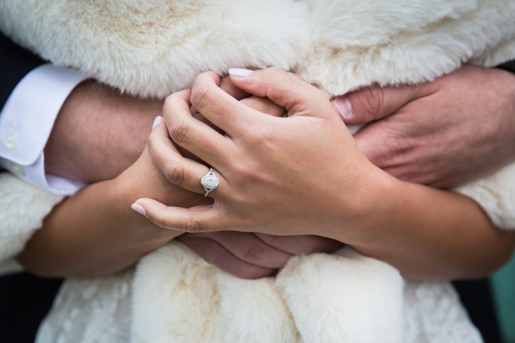 Close up of bride's hands with engagement ring