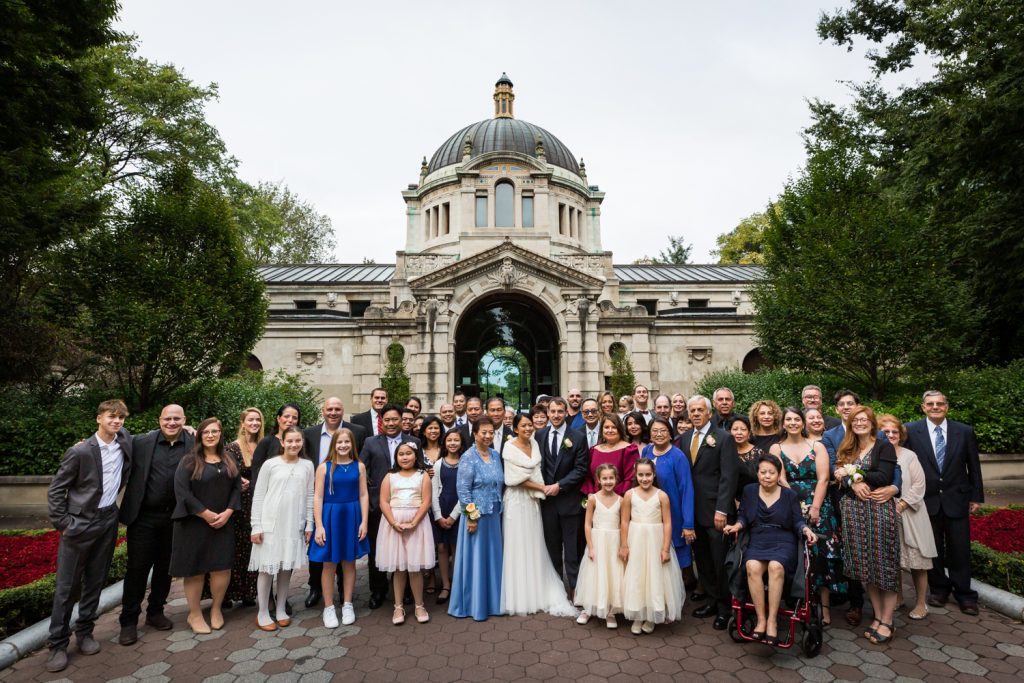 Large family portrait behind Zoo Administration Building for Bronx Zoo wedding photos