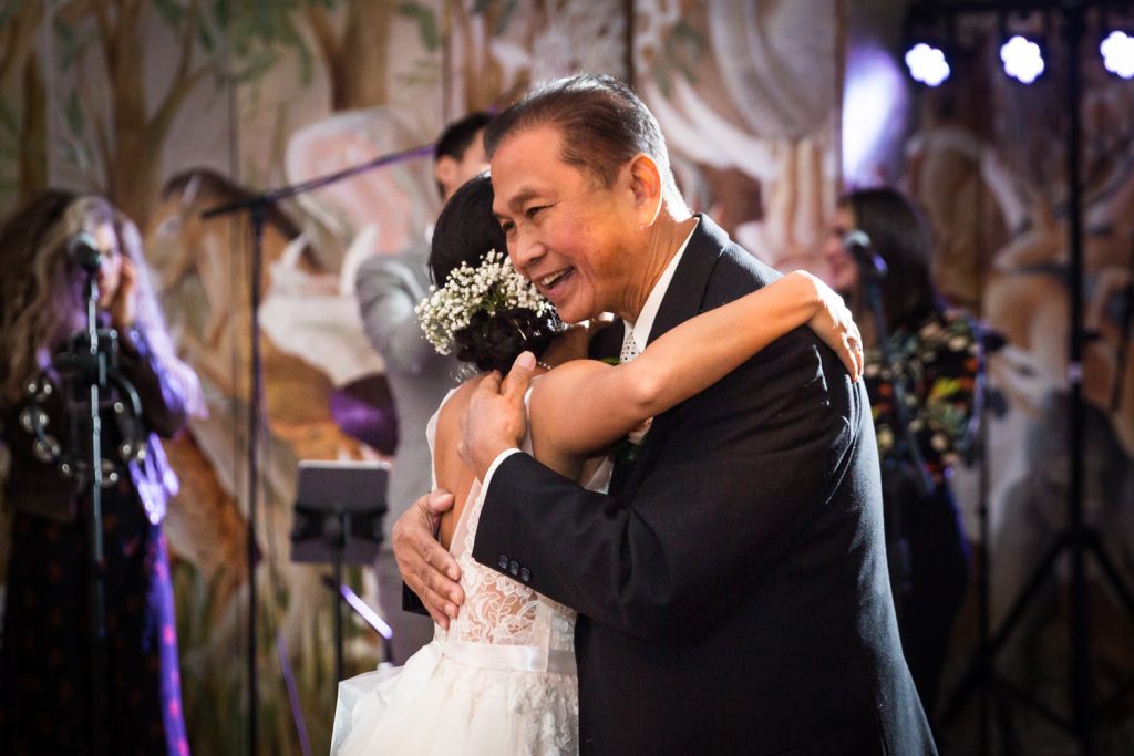 Father embracing bride at Bronx Zoo wedding