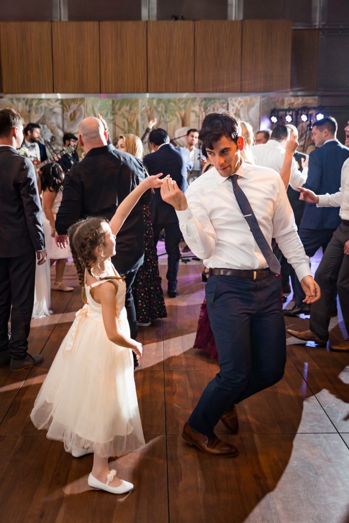 Man dancing with little girl at Bronx Zoo wedding reception