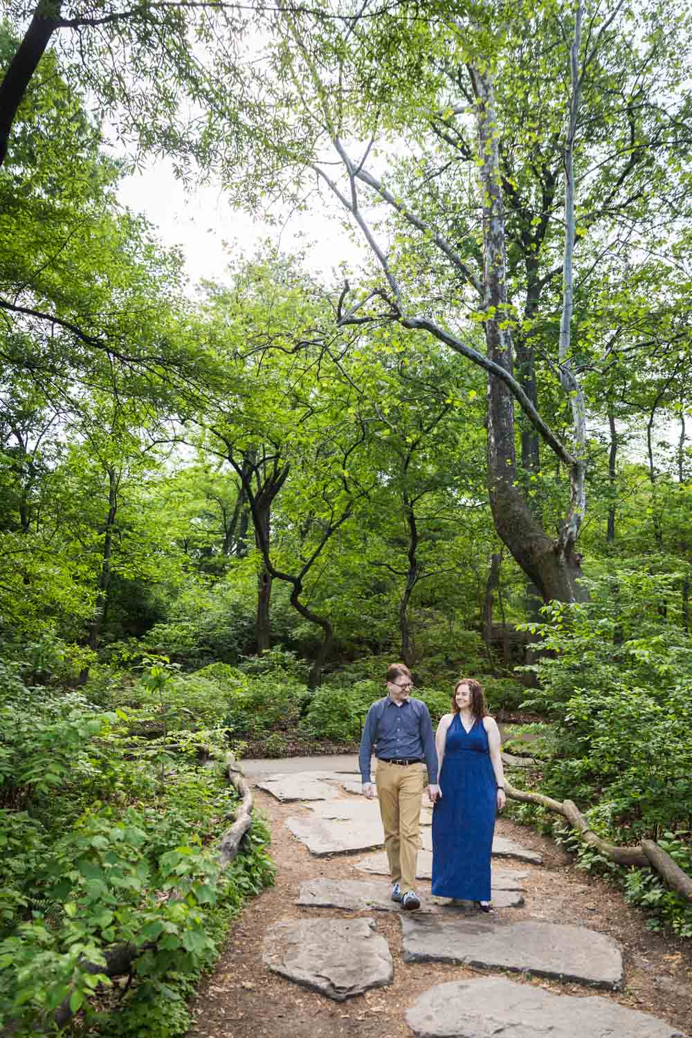 Couple walking down stone path in Central Park