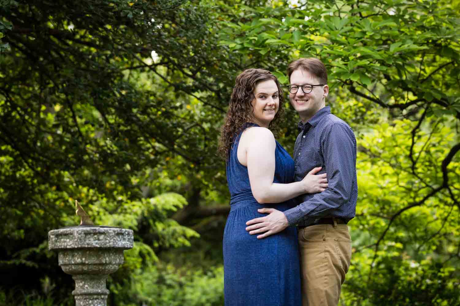 Couple posing in Shakespeare Garden engagement photos