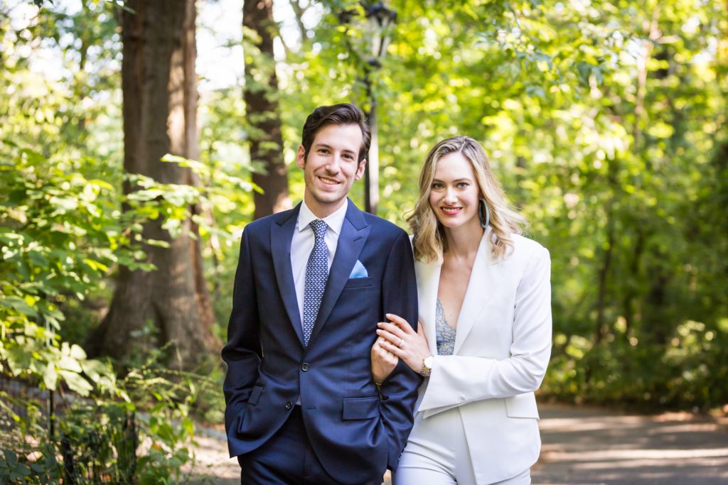 Bride and groom walking arm-in-arm in park for an article on how to modernize your wedding