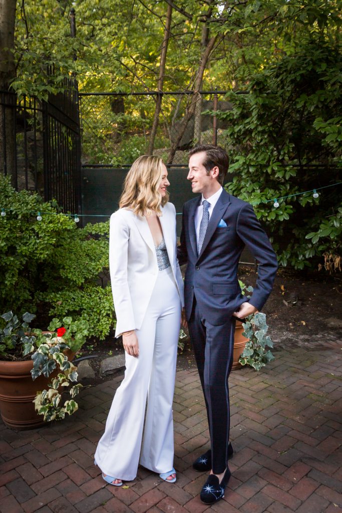 Portrait of Bride in white pantsuit and groom in suit for an article on how to modernize your wedding