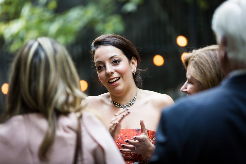 Guest talking to other guest at Central Park wedding cocktail party