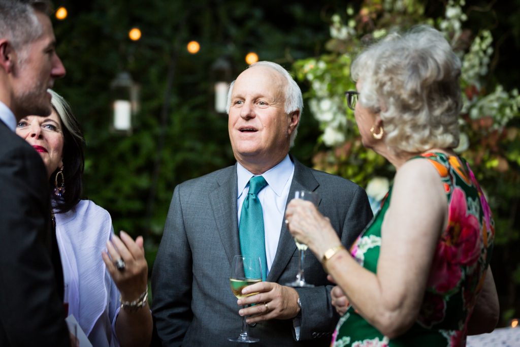 Guest talking to other guest at Central Park wedding cocktail party