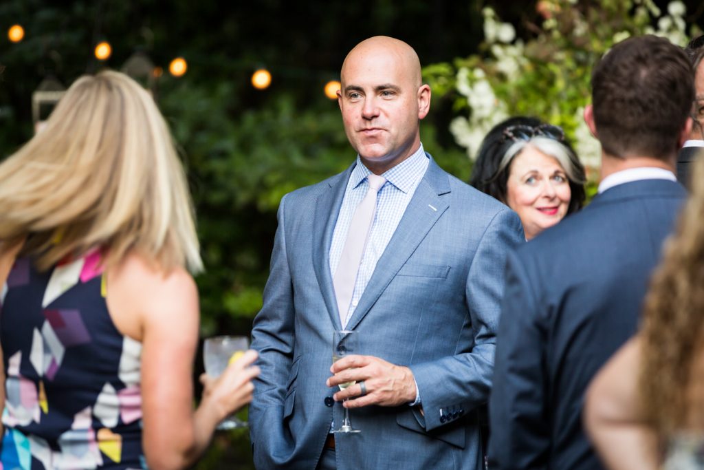 Guest holding wine glass at Central Park wedding cocktail party