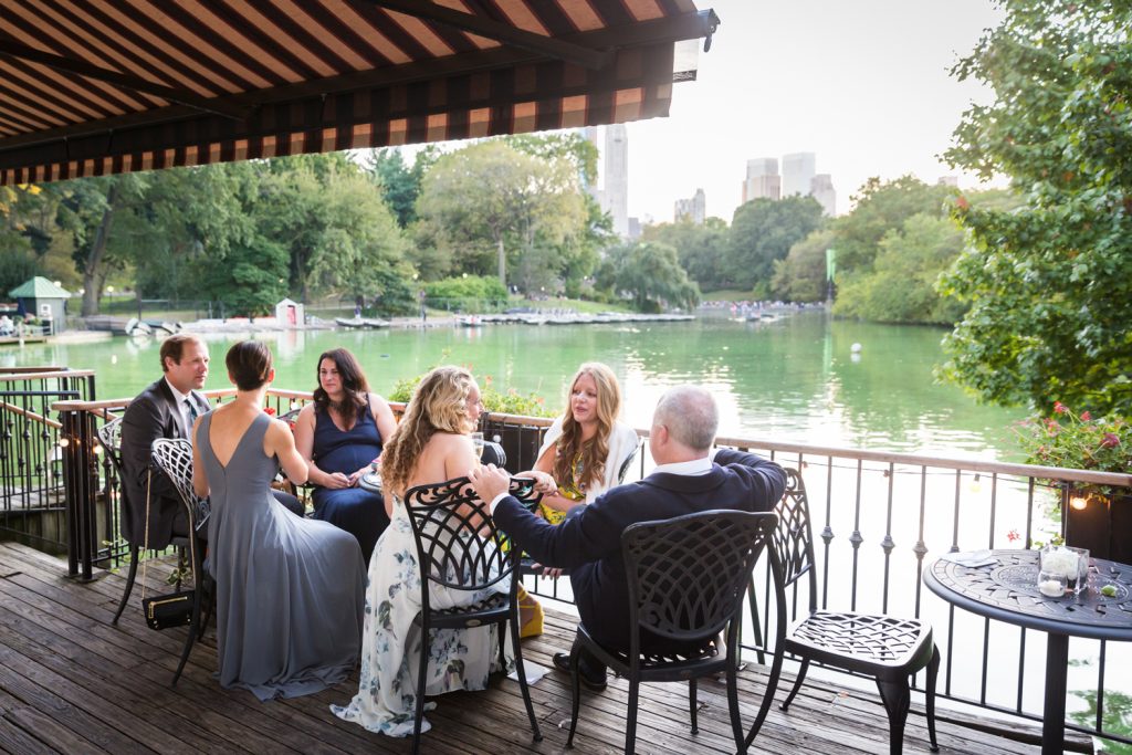 Guests on the patio of the Central Park Boathouse at a wedding cocktail party