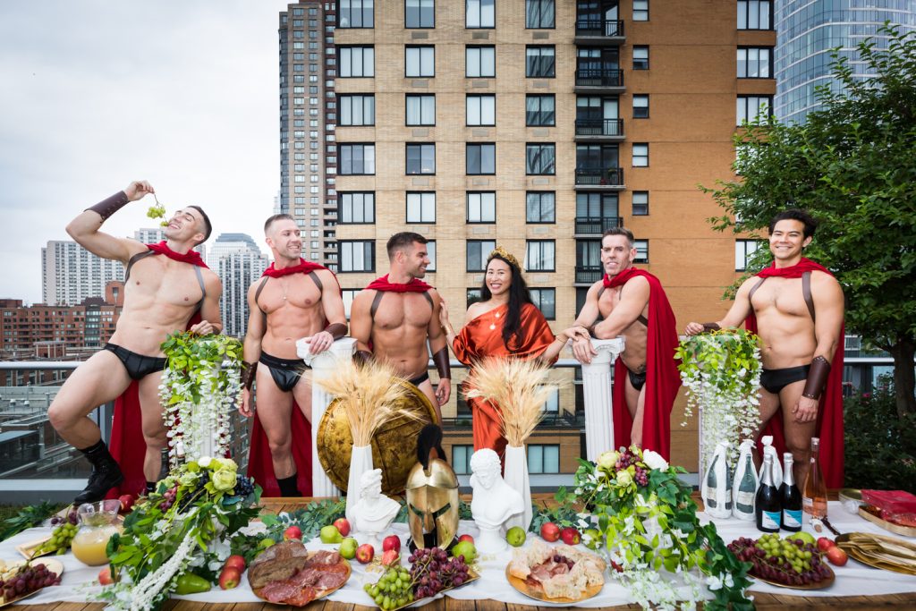 Birthday party photography of people dressed as gladiators behind buffet of food