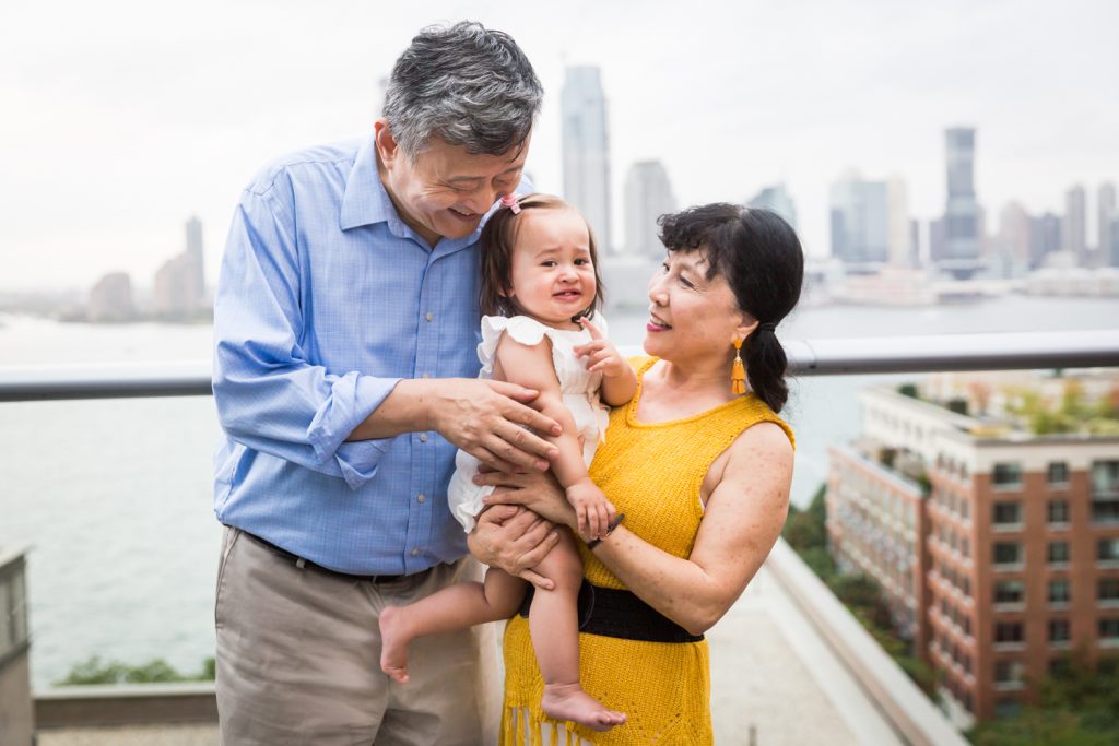 Birthday party photography of grandparents holding little girl
