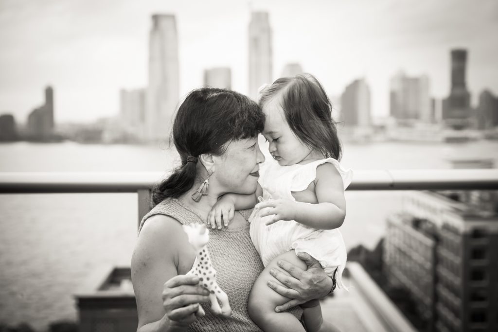 Black and white photo of grandmother holding little girl
