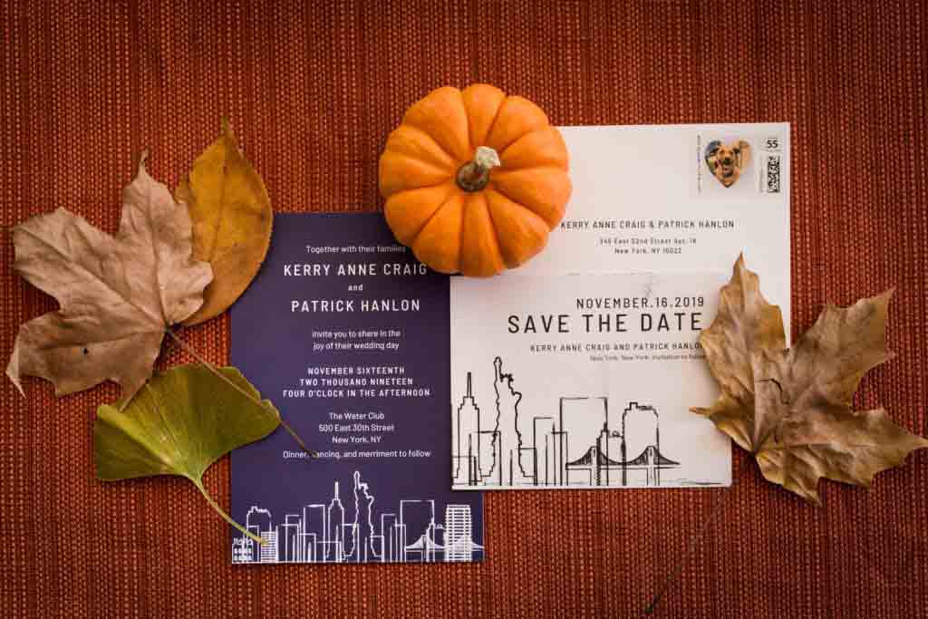 Wedding invitations surrounded by a pumpkin and leaves
