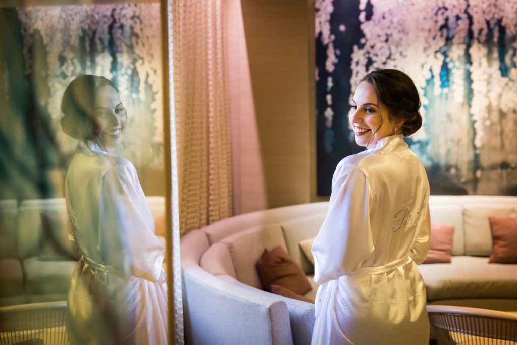 Reflection of bride in white robe at a Water Club wedding