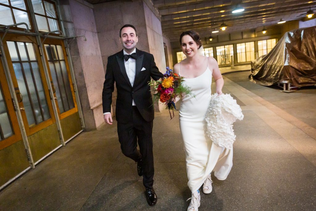 Bride and groom walking into Grand Central Terminal at a Water Club wedding
