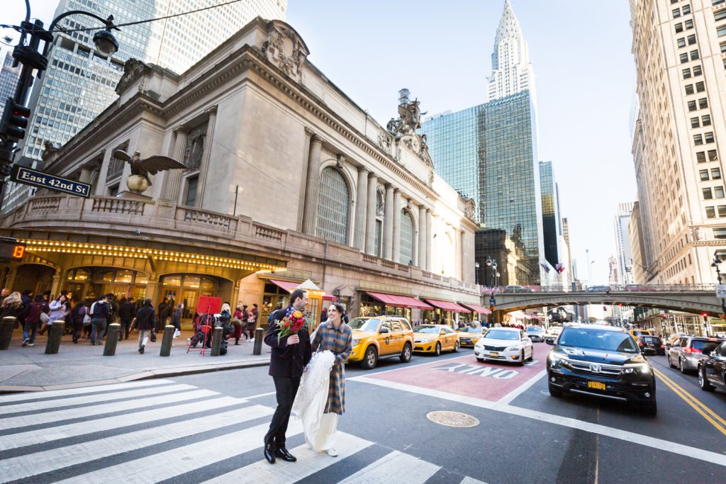 Bride and groom walking in crosswalk across from Grand Central Terminal at a Water Club wedding