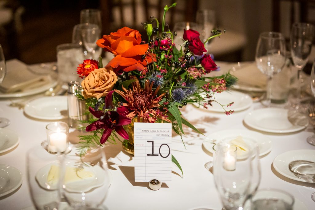 Floral centerpiece and card catalog table number at a Water Club wedding