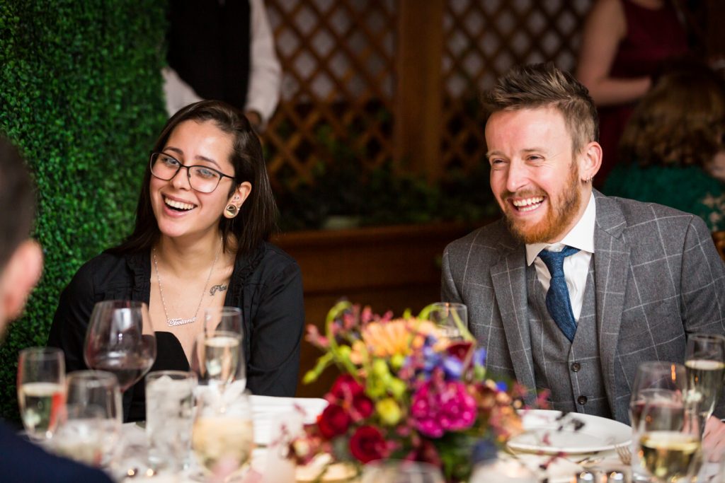 Two guests at a table laughing at a Water Club wedding