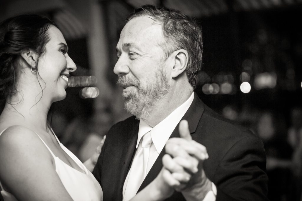Black and white photo of bride dancing with father at a Water Club wedding