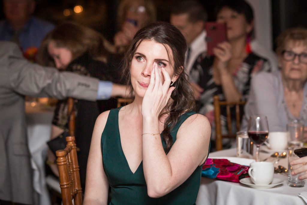 Bridesmaid wiping away tear at a Water Club wedding