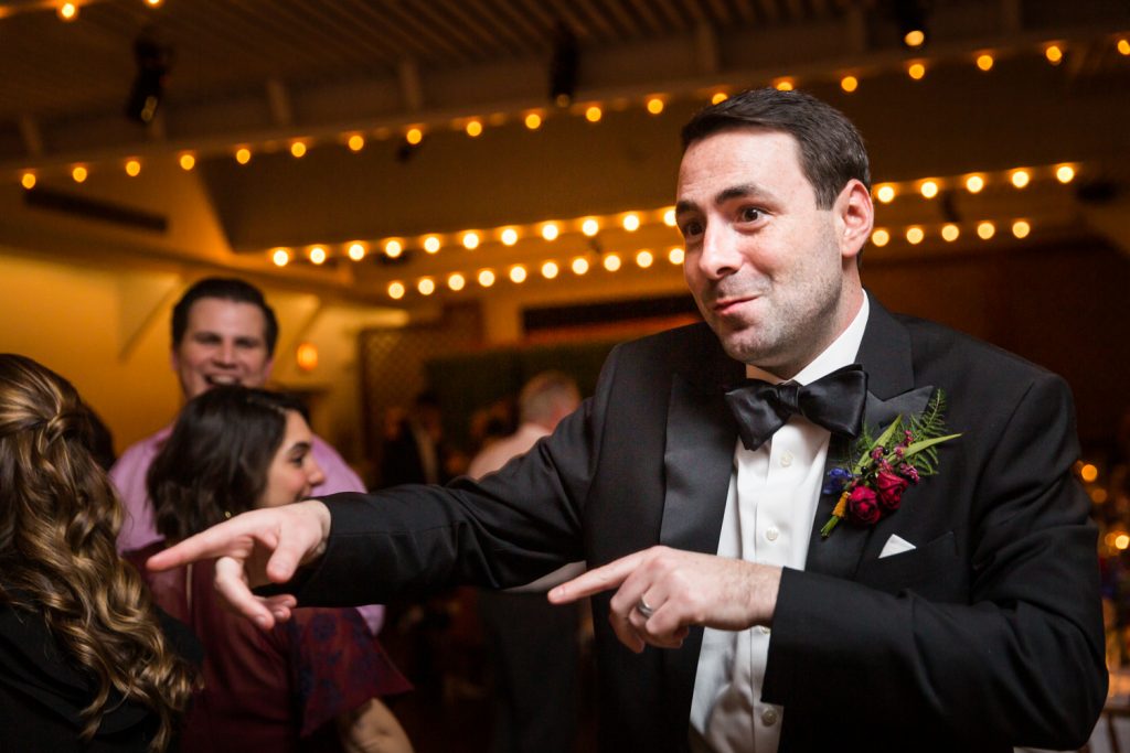 Groom pointing on the dance floor at a Water Club wedding