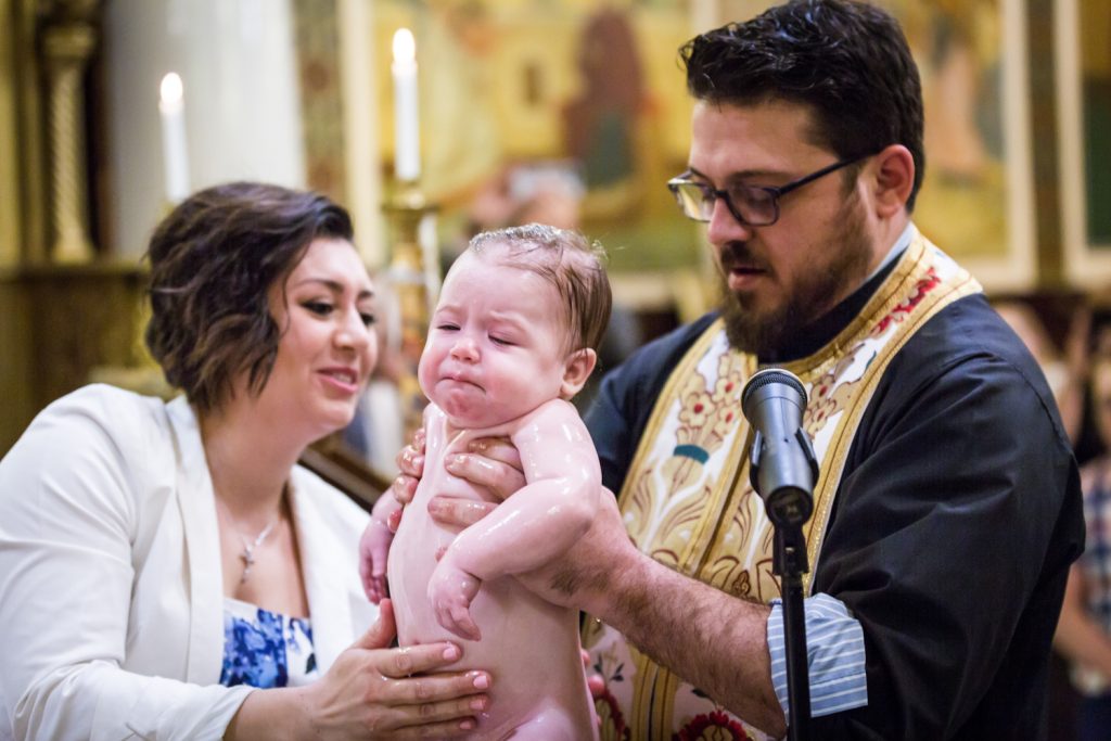 Greek orthodox baptism photos of priest holding baby