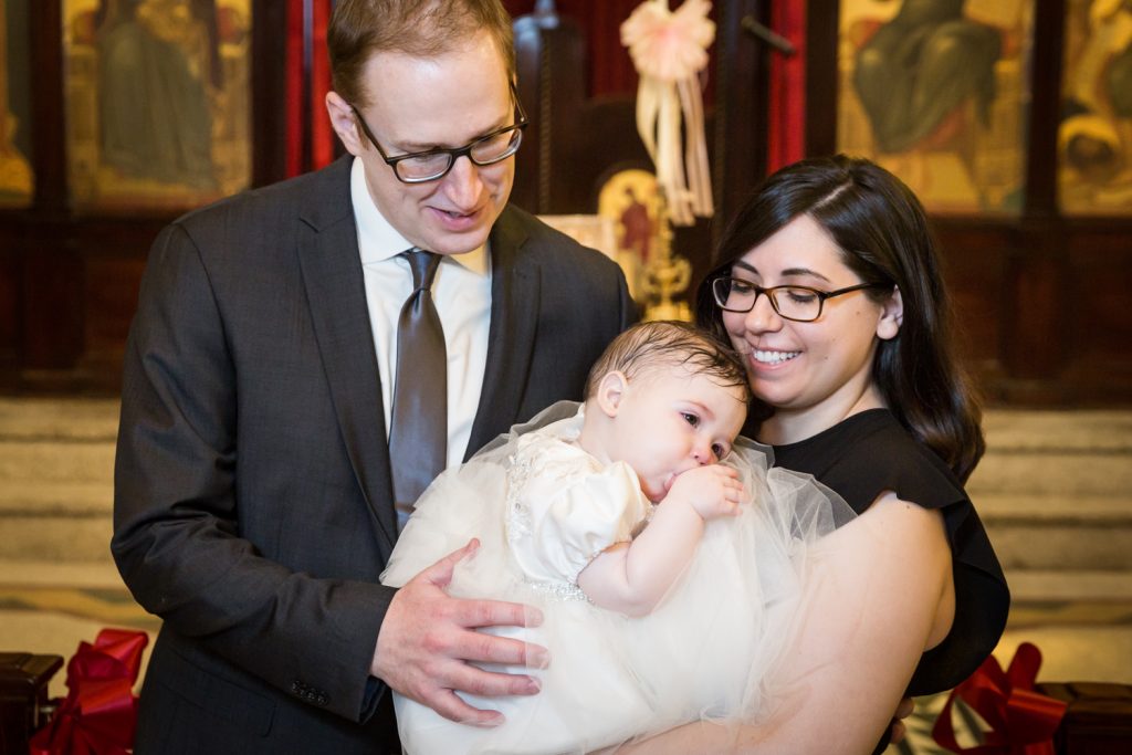 Family portrait of parents with newly baptized baby
