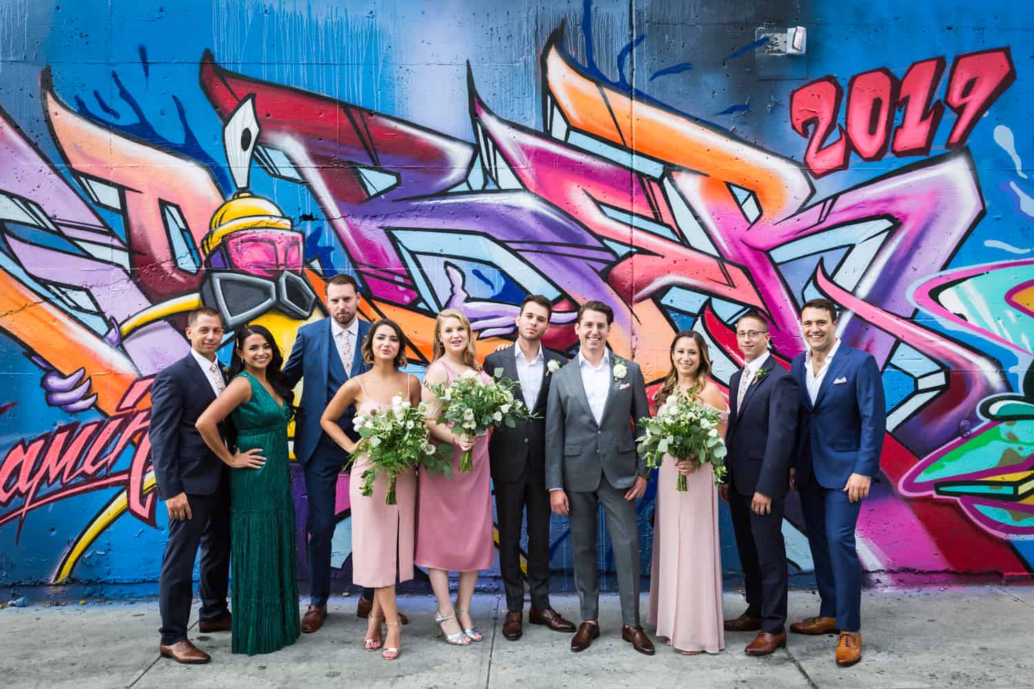 Bridal party in front of colorful mural in Greenpoint, Brooklyn