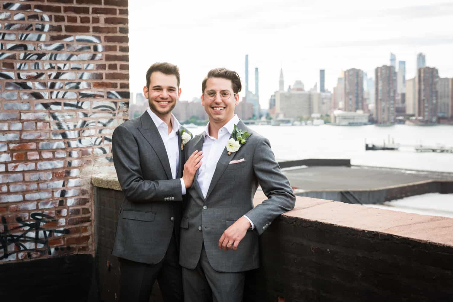 Greenpoint Loft wedding photos of two grooms on the roof with NYC skyline in background