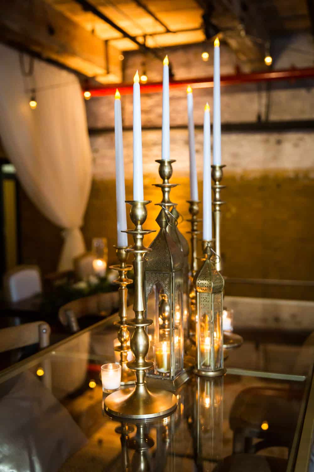 Table with gold candelabras and white tapered candles