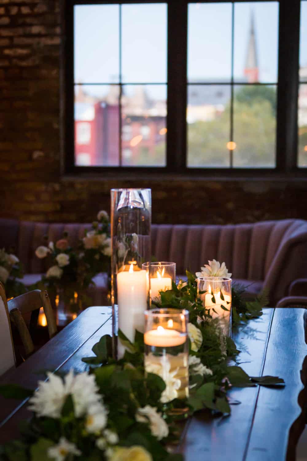 Table with lit candles and flowers