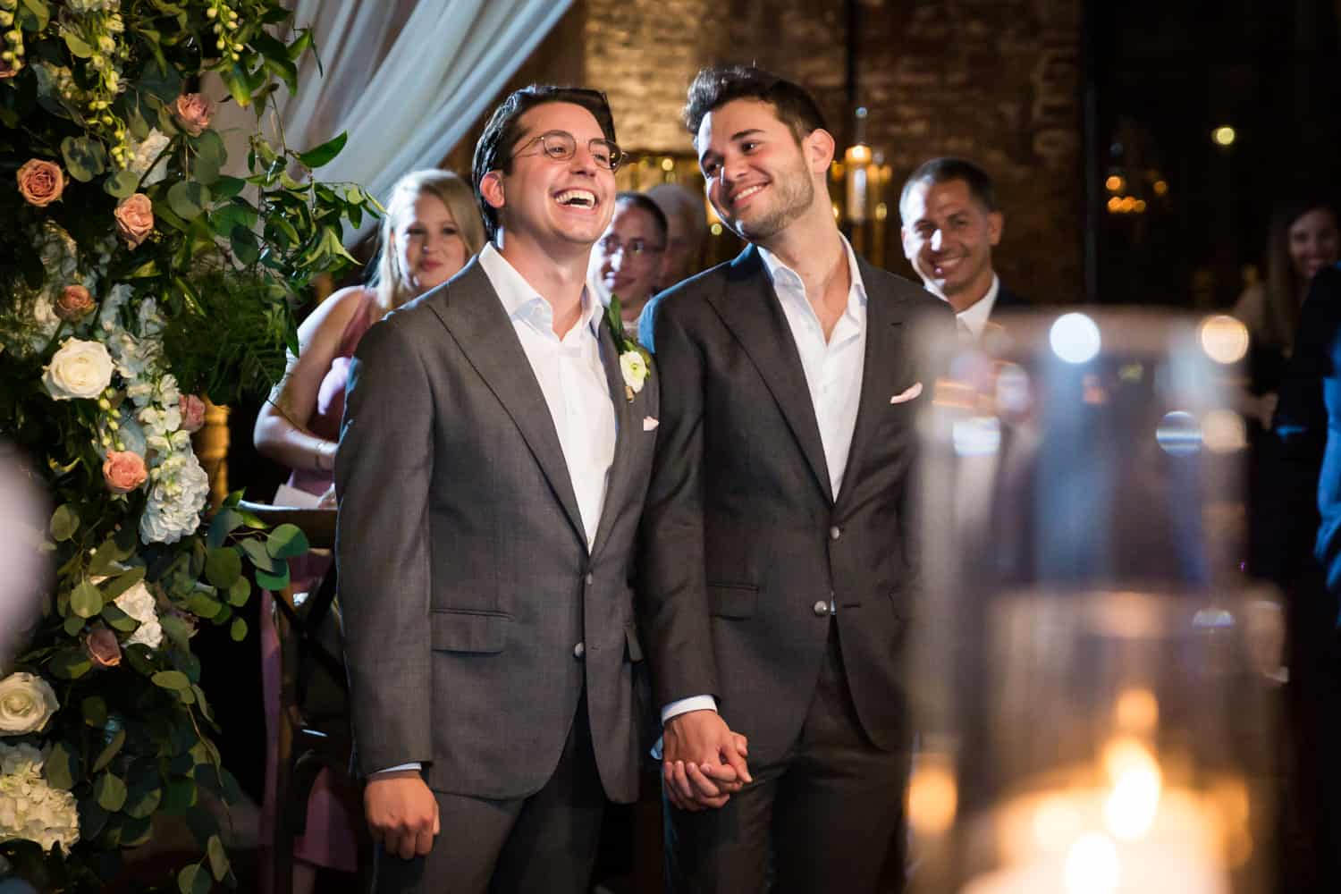Greenpoint Loft wedding photos of two grooms listening to speeches