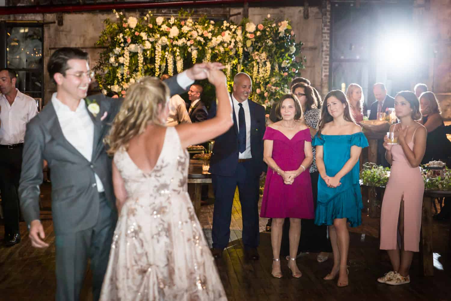 Greenpoint Loft wedding photos of guests watching groom dancing with mother